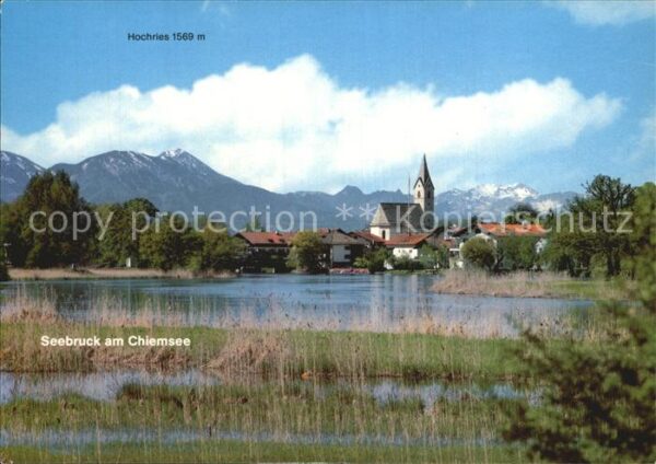 Seebruck Chiemsee Teilansicht mit Hochries und Kirche