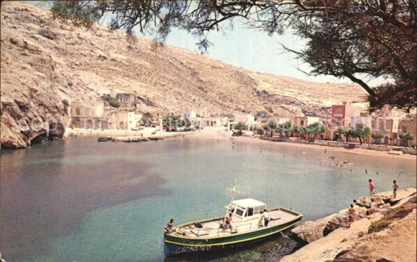 Gozo Malta Xlendi Bay Sandy beach with towering cl